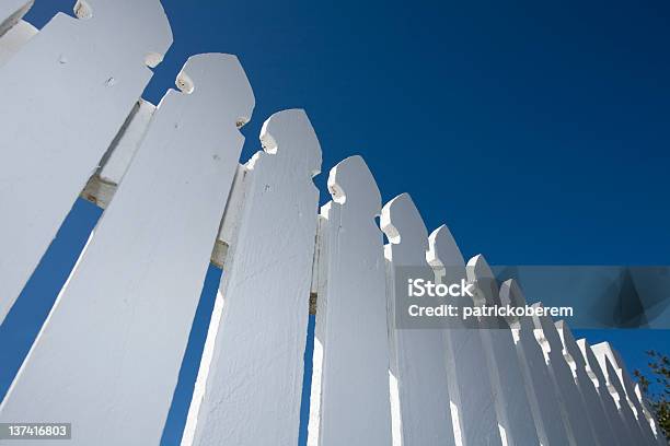 Wormseye View Of White Picket Fence And Blue Sky Stock Photo - Download Image Now - Fence, Horizontal, House