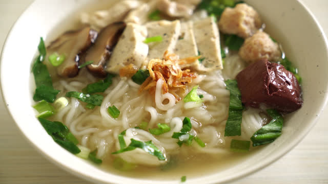 Vietnamese Rice Noodles Soup with Vietnamese Sausage served vegetables and crispy onion - Asian food style