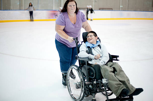 jeune homme patinage sur glace - sports en fauteuil roulant photos et images de collection