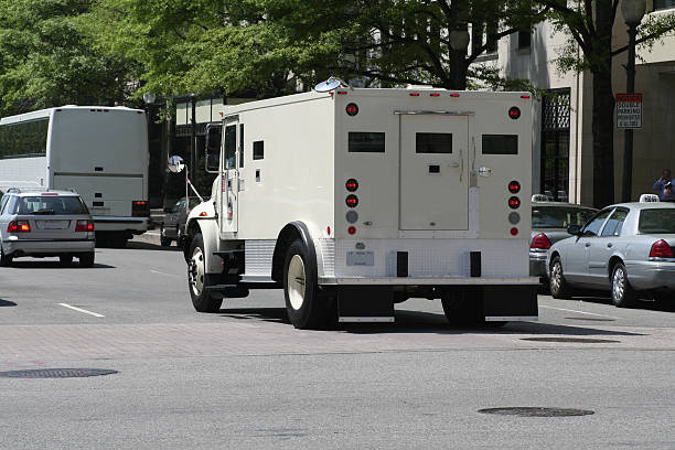 Armoured Car Armored Car in traffic. - See lightbox for more armoured truck stock pictures, royalty-free photos & images