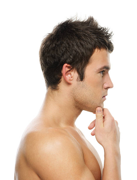 Portrait of young man with hand on his chin stock photo