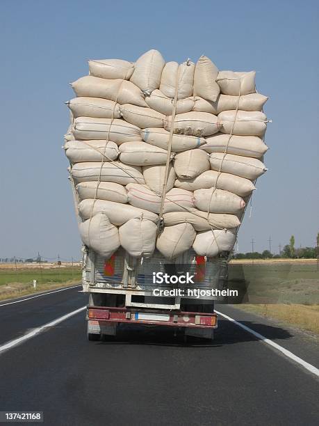 An Overloaded Truck Leans To The Side Stock Photo - Download Image Now - Over-Burdened, Truck, Excess