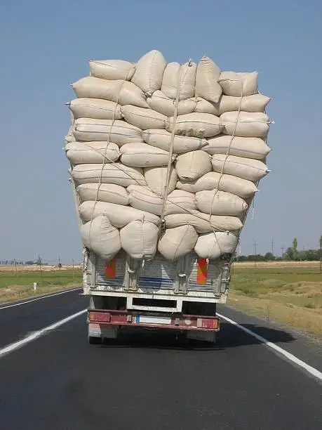 Photo of An overloaded truck leans to the side