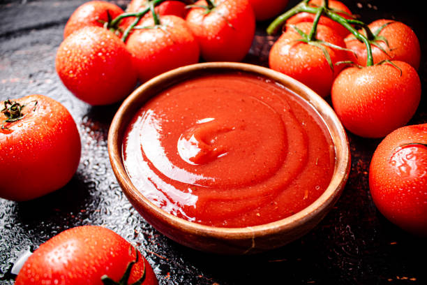istock Tomato sauce with a branch of fresh tomatoes. 1374218090