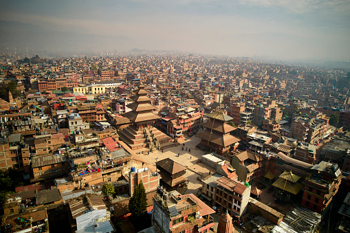 Aerial point of view over Bhaktapur, 8 miles east of Kathmandu, with UNESCO World Heritage Site and sprawling city surrounding plaza and palace complex.