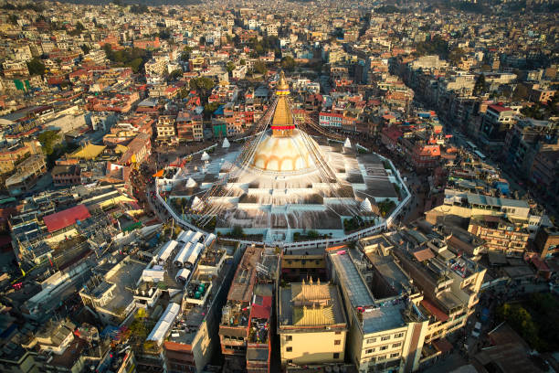 City surrounding Buddhist temple with wisdom eyes, prayer flags, and massive mandala, making it one of the largest spherical stupas in Nepal and the world.