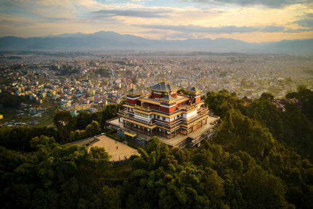 Fulari Gumba from drone point of view, Nepal Elevated perspective of Pullahari Monastery, Buddhist pilgrimage site on northern hill in Kathmandu Valley with city and mountains in background. nepal stock pictures, royalty-free photos & images