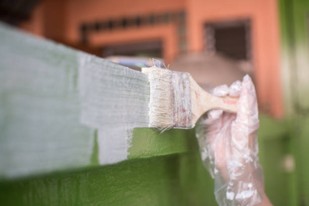 istock Paint brush painting a wall 1374225288