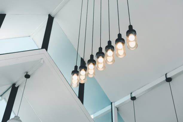 istock Restaurant Interior Light Bulb Decoration Styles, Electrical Overhead Lightbulb Hanging on Ceiling in The Living Room. Interiors Decorative Architecture Modern Design of The Restaurant. Electric Light 1374229340