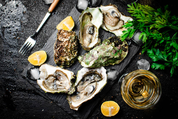 istock Fresh oysters with greens. On a black background. 1374229935