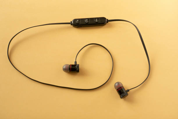 istock Wireless portable headphones in black, closeup. Smartphone accessory. 1374267884