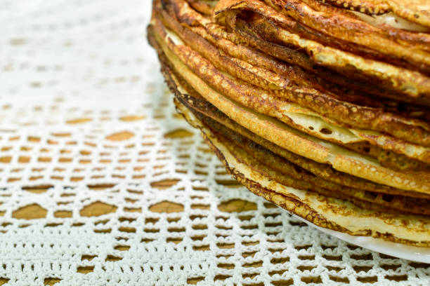 istock Pancakes stacked against a white lace tablecloth 1374302971