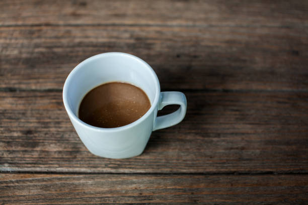 istock Cup of coffee on wooden table 1374307138