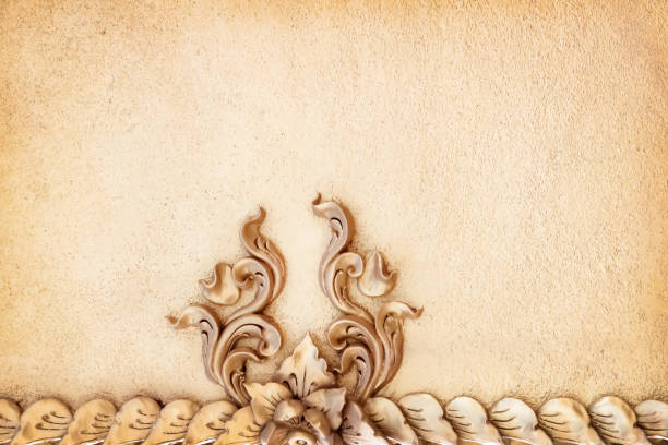 istock Leaf and flower with engraving stucco decorative on old brown cement wall in temple background 1374357076