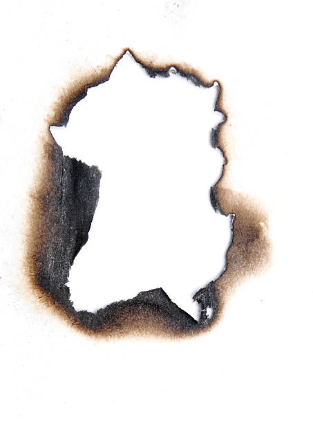 hole burnt hole in a paper burning stock pictures, royalty-free photos & images
