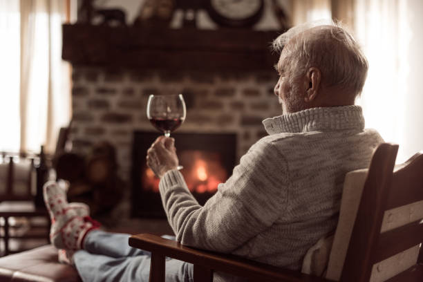 Senior man drinking red wine stock photo