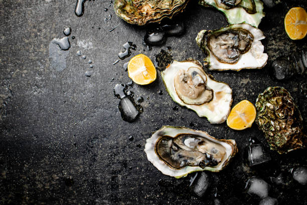 istock Oysters with pieces of ice and lemon. 1374388238
