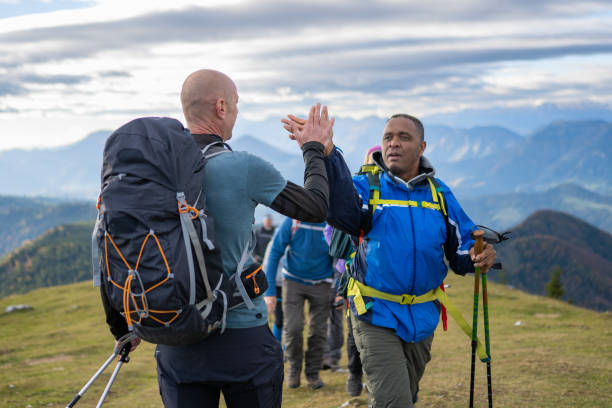 istock Smiling hikers giving high-five 1374414796