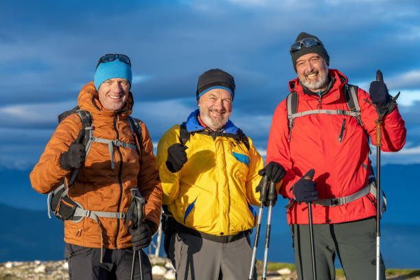 istock Smiling friends standing against sky 1374414827