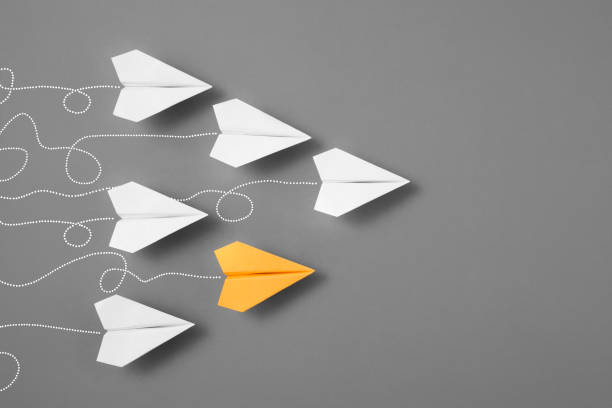 istock Yellow Airplane with White Paper Planes 1374451690