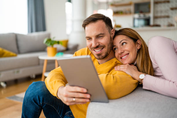 istock Young couple at home websurfing on tablet, internet 1374452708