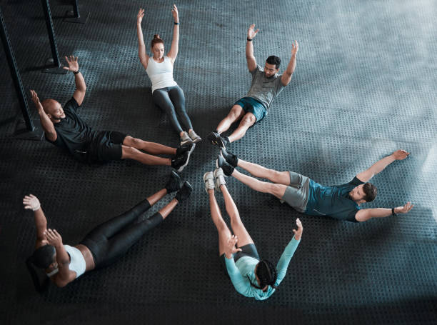 istock Shot of a group of workout partners completing crunches together 1374452798