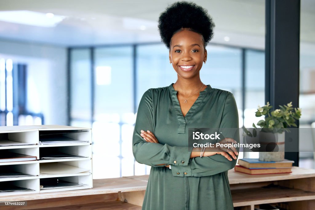 Shot of a young businesswoman standing in an office at work Always taking care of my business Women Stock Photo