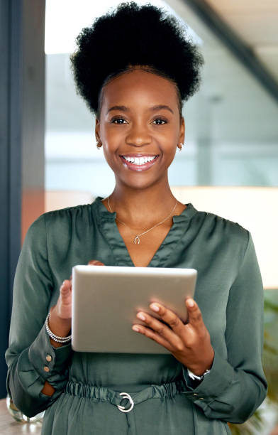 istock Shot of a young businesswoman using a digital tablet at work 1374454384
