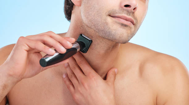 istock Shot of a young man shaving his face against a studio background 1374454567