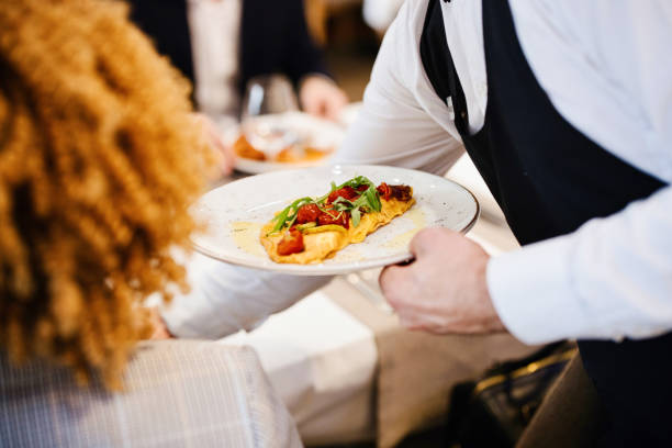 istock Waiter serving breakfast to the guests 1374457398