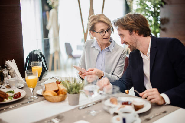 Business people talking while having a breakfast at the restaurant.
