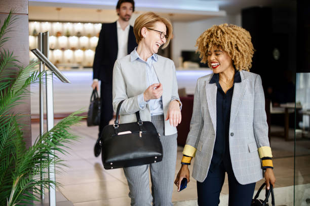 istock Businesswomen talking while walking side by side 1374462885
