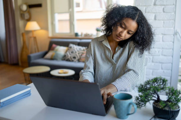 istock Young woman working from home on laptop 1374470746