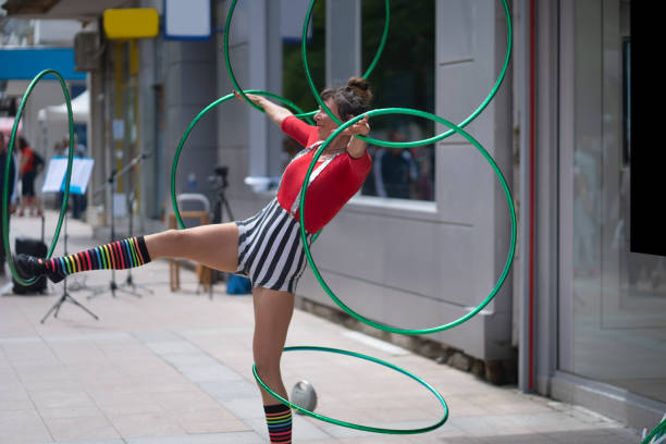 istock A street artiste is performing spinning tricks with hoops 1374470881