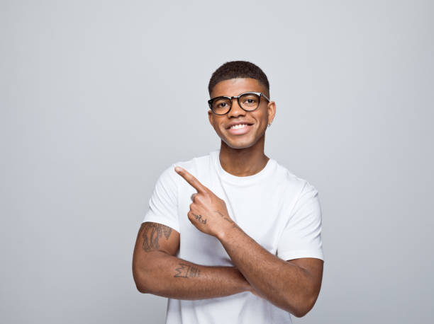 istock Cheerful young man pointing at copy space 1374470915