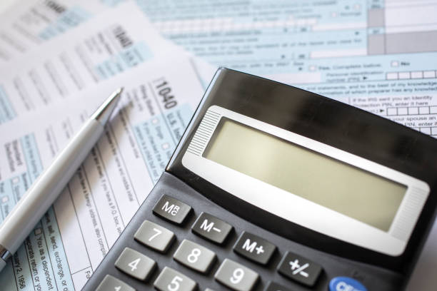 Income tax documents ( form 1040) with calculator
