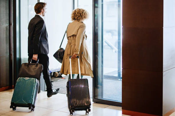istock Multi-ethnic business couple leaving hotel 1374473546