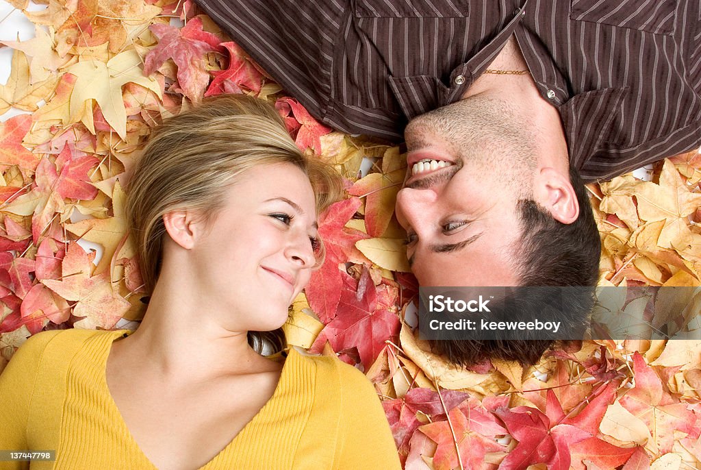 Love in fall Couple in fall leaves Adolescence Stock Photo