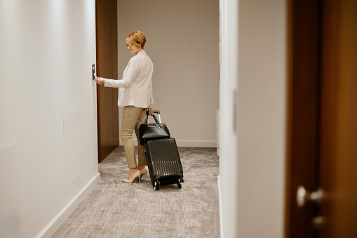 Businesswoman searching for her room at the executive floor of the luxury hotel