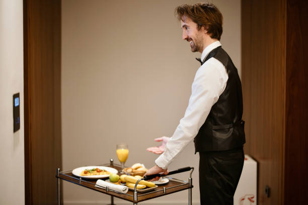 istock Room Service. Waiter bringing breakfast to the hotel room 1374481994