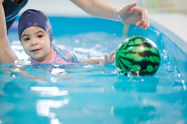 istock Cute girl in swimming pool 1374495958