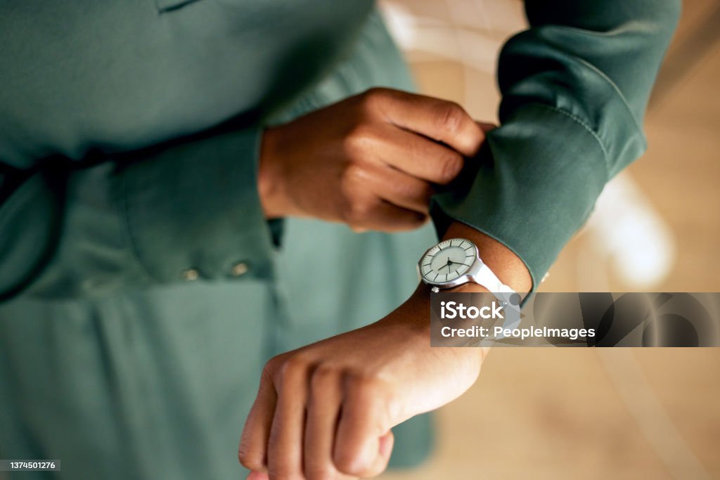 Shot of an unrecognizable businessperson checking the time at work Looks like it's time for business Checking the Time Stock Photo