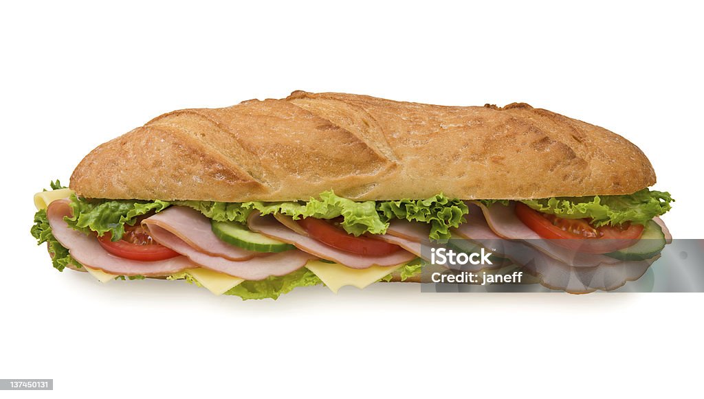 Extra large submarine sandwich with ham and cheese Delicious foot-long submarine sandwich with ham, swiss cheese, lettuce, tomatoes and cucumbers isolated on white background, front view Submarine Sandwich Stock Photo