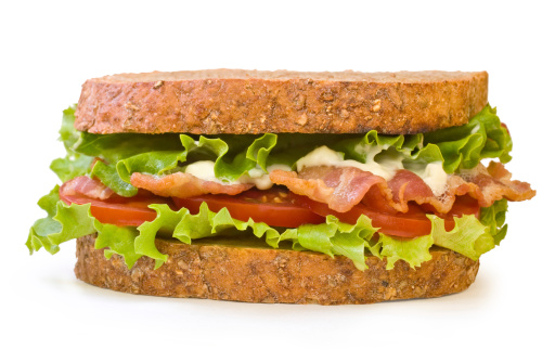 Whole wheat toasted BLT (Bacon, Lettuce, Tomato) sandwich with mayonnaise isolated on white background