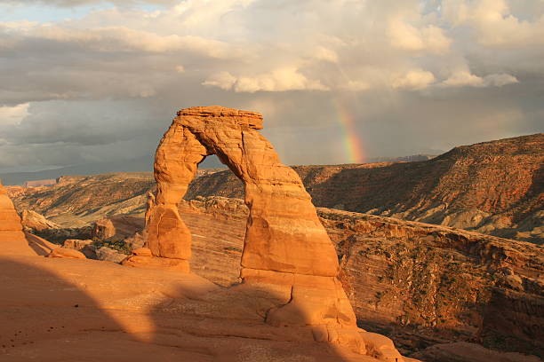 Delicate Arch with rainbow in Arches National Park, Utah stock photo