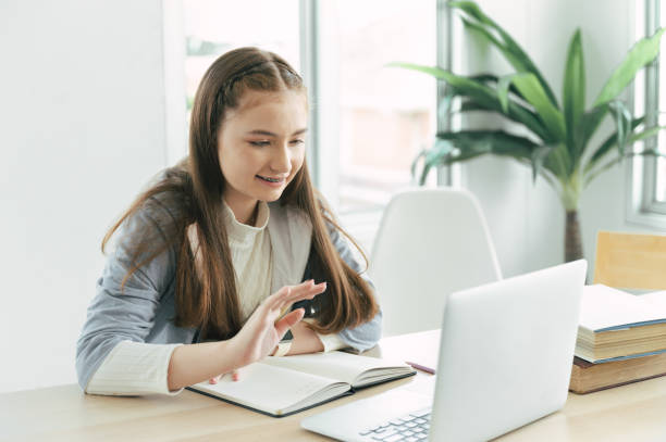 istock Happy girl student online learning class with laptop computer 1374518365