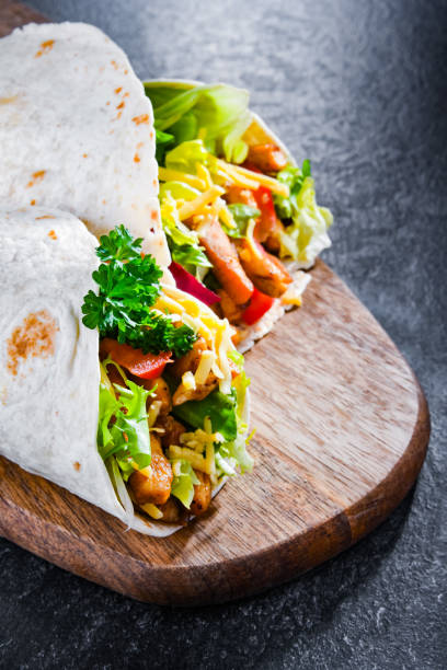 istock Tortilla with chicken and fresh vegetables on a cutting board 1374518413