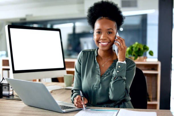 istock Shot of a young businesswoman using a laptop while on a call at work 1374518599