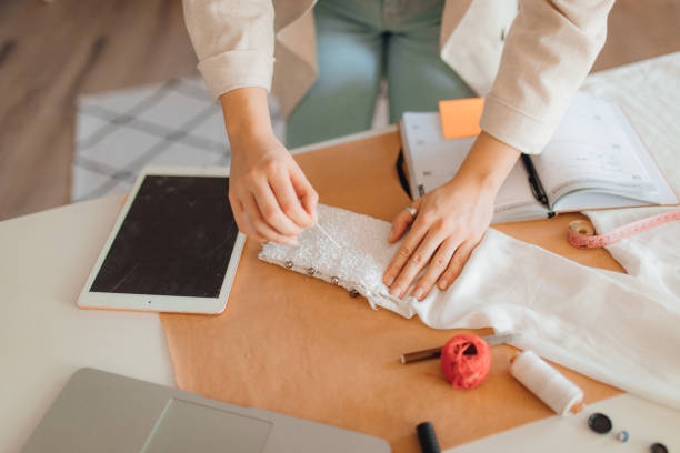 istock Young fashion designer working in her atelier 1374528449