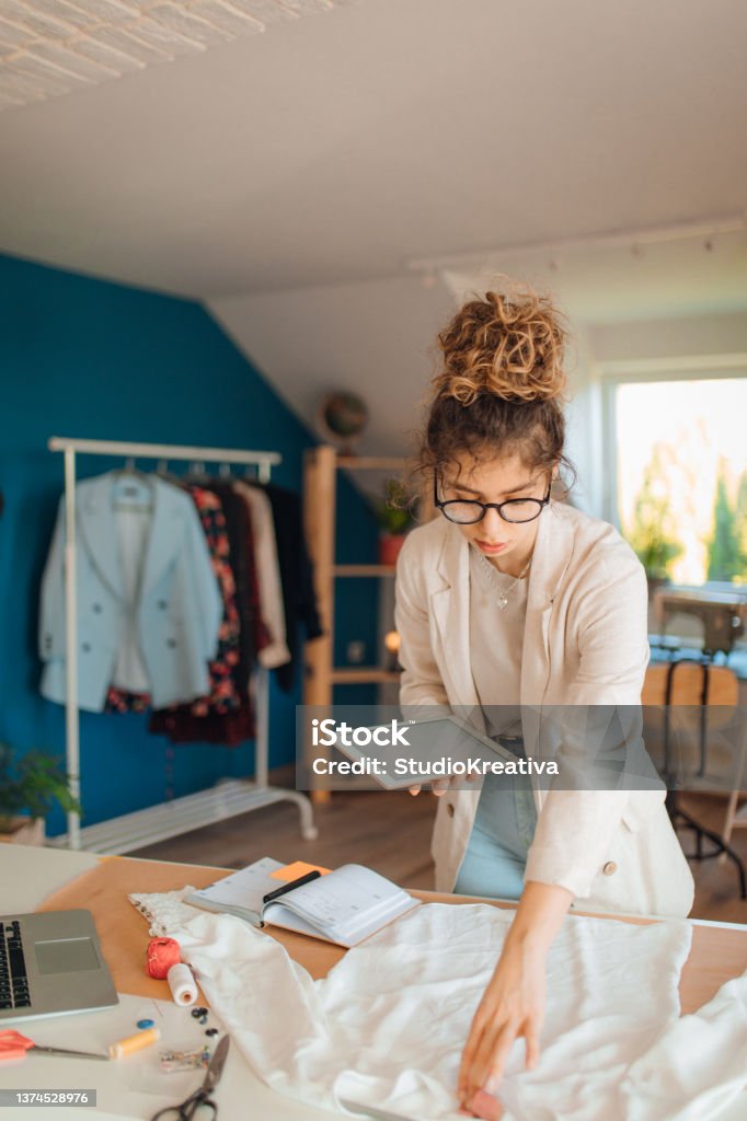 Young fashion designer working in her atelier Fashion Stylist Stock Photo